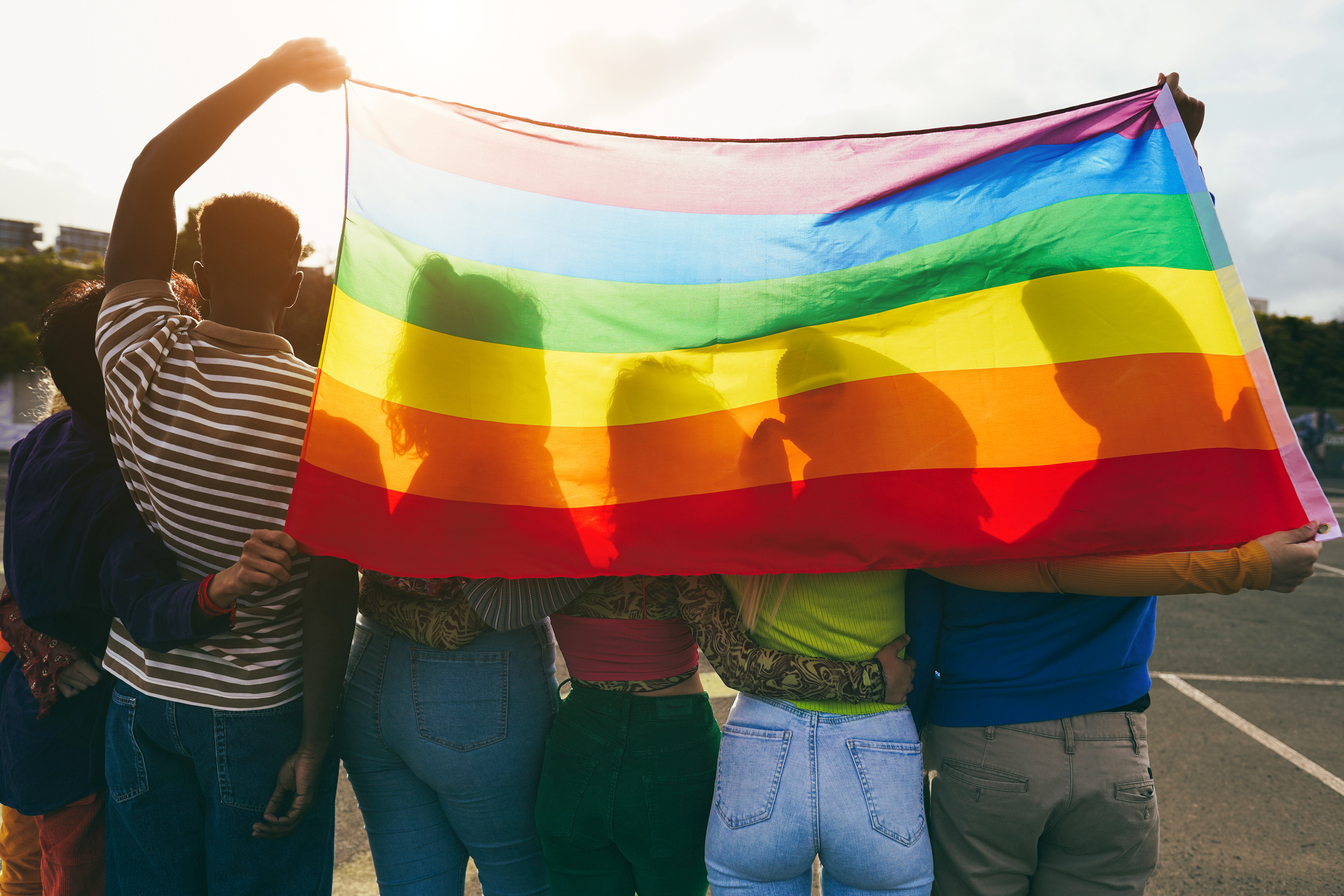 Friends holding flag in the sun